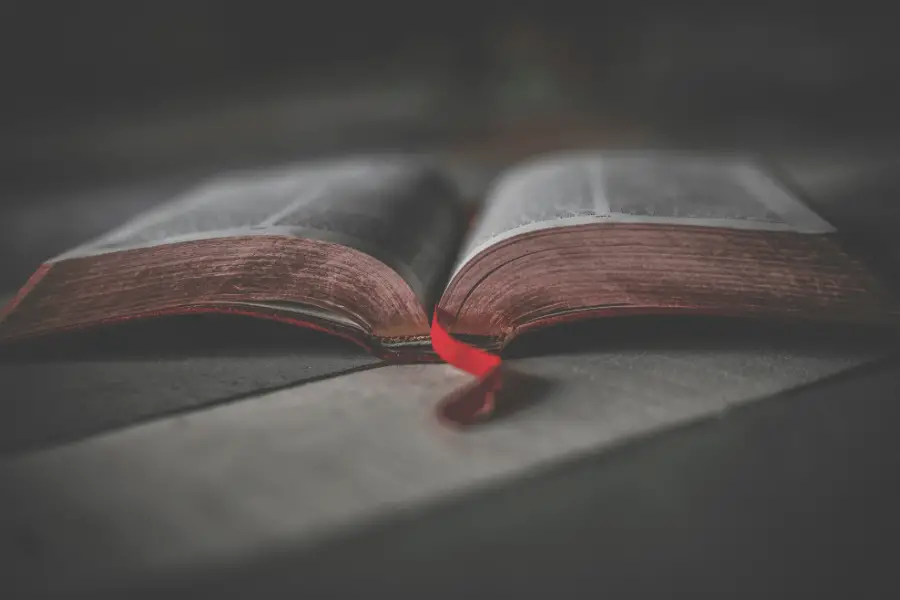 Open Bible With Red Ribbon On Table