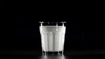 Milk In Glass With Black Background