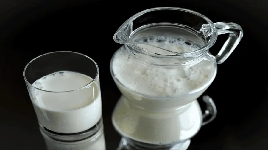 Milk In Glass And Pitcher With Black Background