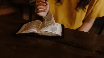 Woman Turning Page In The Bible