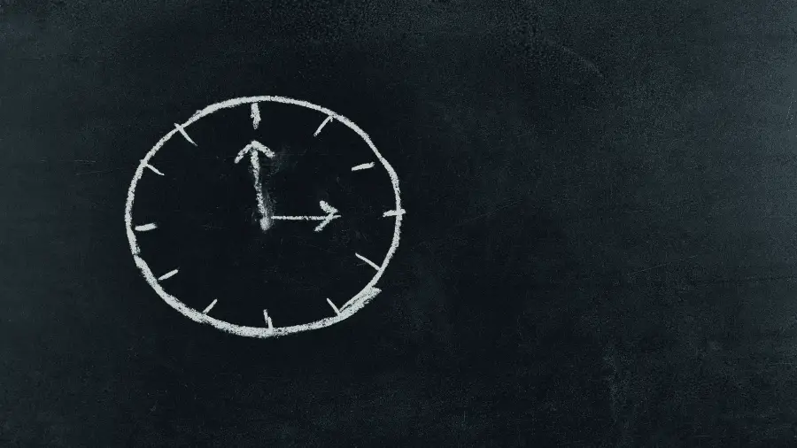 Analog Clock Drawn On Chalkboard