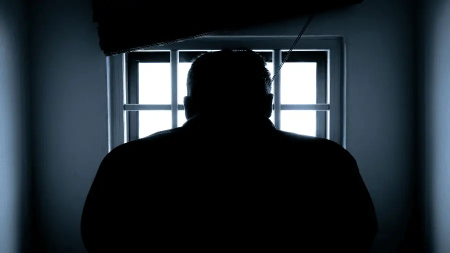 Man In Dark Near Window With Light 900x506