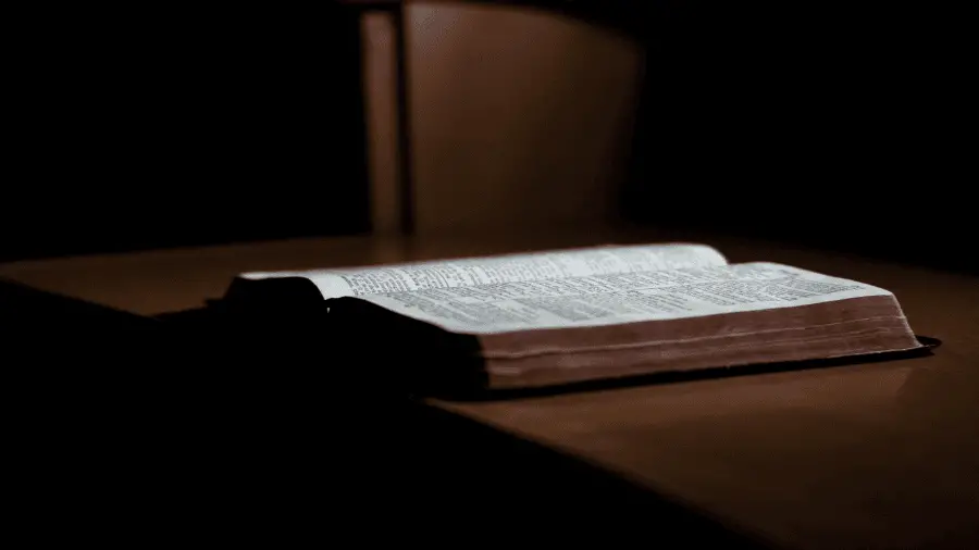 Bible On Table In Dark Room 900x506