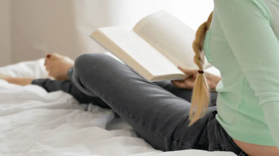 Woman Resting On Bed Reading 900x506