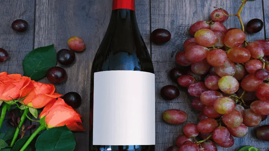 Red Wine Bottle On Table With Fruit 900x506