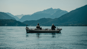 2-Fisherman-On-Boats-With-Mountain-In-Background-356x200