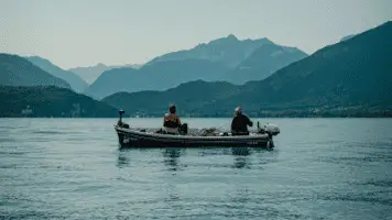 2-Fisherman-On-Boats-With-Mountain-In-Background-356x200