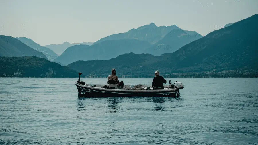 2-Fisherman-On-Boats-With-Mountain-In-Background-900x506